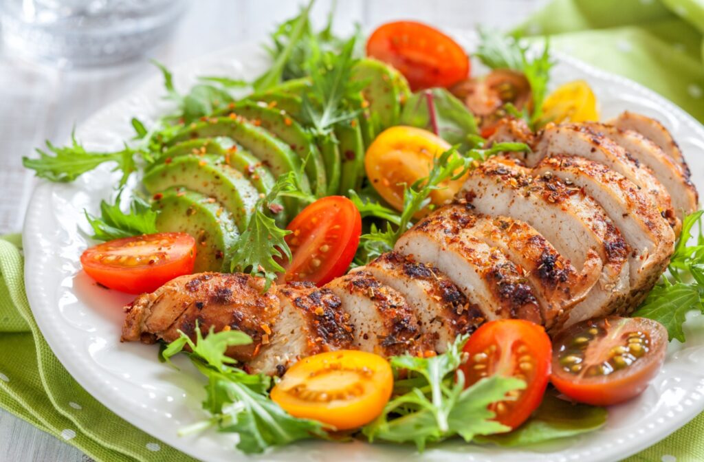 A close-up image of a senior-friendly Cobb salad with chicken, lettuce, and fresh tomatoes.